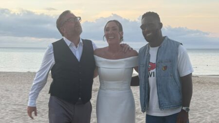 Tinie Tempah turns wedding crasher as he poses for photos with a bride and groom on the beach in Cornwall after performing at Boardmasters