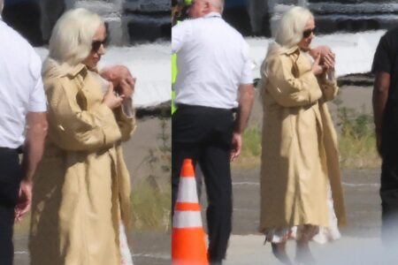 Glam Lady Gaga cradles her baby as she touches down in LA with fiancé Michael Polansky